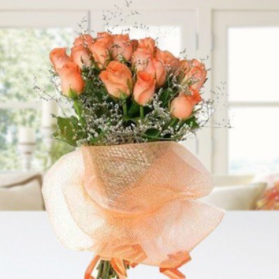 Bunch of 15 Orange Roses with white fillers in orange net packing Running Success