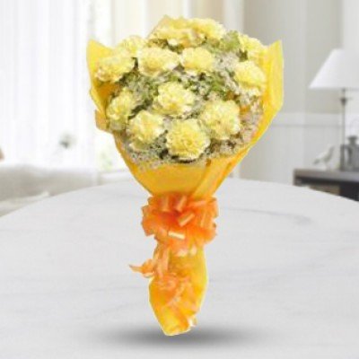 Bunch of 12 Yellow Carnations with white fillers in yellow wrapping Twisted Love