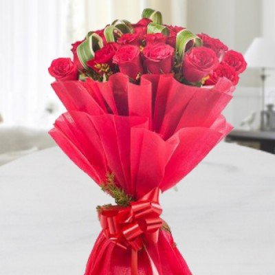 Bunch of 50 Red Roses with lots of fillers in Red Paper Packing with Red Ribbon. Romance