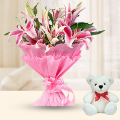 Bunch of 8 Pink Oriental Lilies with fillers and greenery in nice pink wrapping paper along with 6 Inch Teddy Bear Dazzle Lily
