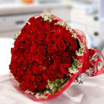 Bunch of 60 Red Roses with seasonal fillers wrapped in Net Private Party