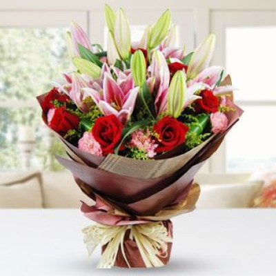 Bunch of 4 Stems of Pink Lilies, 10 Red Roses & 6 Pink Carnations with fillers in nice wrapping Red and Pink Beauty