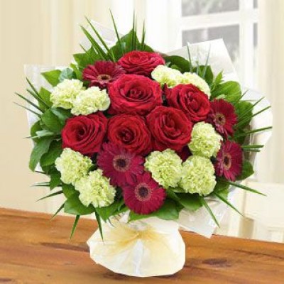 Bunch of 9 Green Carnations, 4 Red gerberas & 6 Red Roses with fillers in nice wrapping Her Beautiful Smile