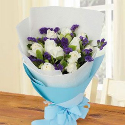 Bouquet of 12 Roses wrapped around with 5 stems of Purple Statice and Ruscus Leaves, paper wrapper and ribbons. Cherished
