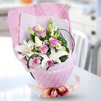 Bunch of 7 Purple roses and 4 stems of white lilies with fillers in a Fan shaped wrapping Lily Rose Bouquet