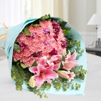 Hand banquet of 20 pink carnations, 2 stem pink lilies with waxflower and green in nice wrapping Enchantment Bouquet