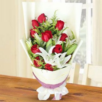 Hand bouquet of 11 red roses with 2 stem white lilies and greens in nice wrapping (As image) Stolen Kisses