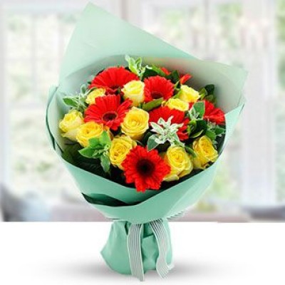 Bunch of 10 yellow roses and 7 Red gerberas with fillers in nice wrapping Tropical Bouquets
