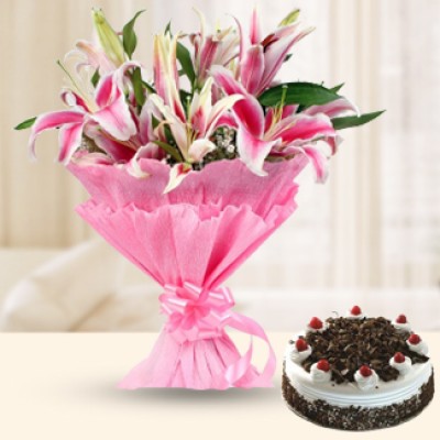 Bunch of 8 Pink Oriental Lilies with fillers and greenery in nice pink wrapping paper along with 1/2 Kg Black Forest Cake Pink Lilies & Cake