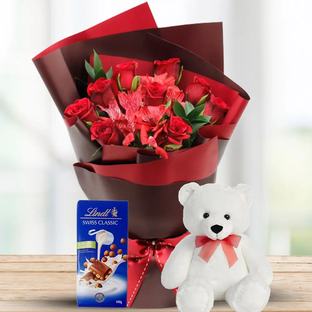 Bouquet of 9 Red Roses with 3 stems of Red alstroemeria and ruscus leaves in nice wrapping with Lindt Chocolate Bars 100g & 6 inches Teddy. Richness Combo