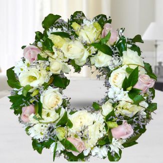 Wreath Arrangement of Pink and white roses and white chrysanthemums, tiny accent blossoms, and green foliages White and Cream Wreath