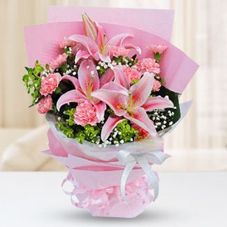 2 pink perfume lilies, 11 pink carnations, baby's breath and foliages. Pink crepe paper, glass paper fan-shaped packed and pink ribbon. Radiant Pink