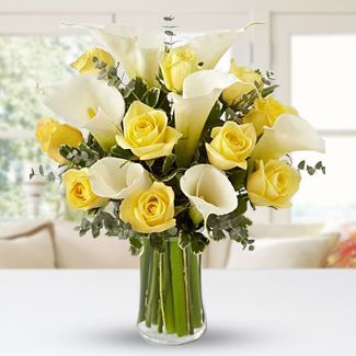 10 Yellow roses & 6 Calla Lilies with fillers in a Glass Vase Simply Enchanting