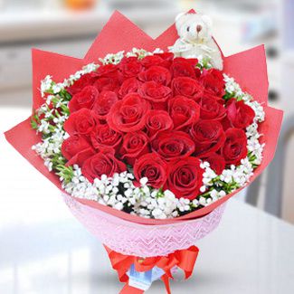 40 Red Roses with fillers and a mini teddy bear in nice Paper packing. Red Rose Day